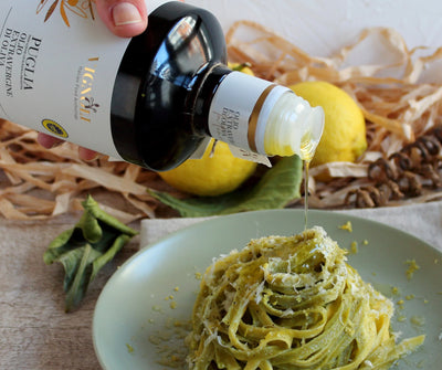 Puglia Extra Virgin Olive Oil pouring onto pasta