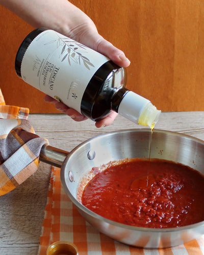 Tuscan Extra Virgin Olive Oil pouring into pasta sauce