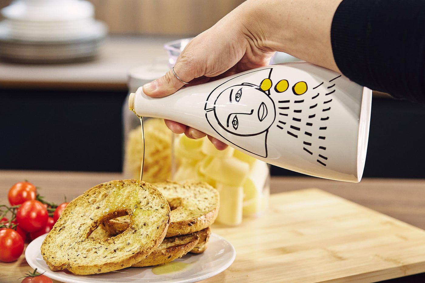 Ceramic olive oil bottles in white with hand painted design used on bread