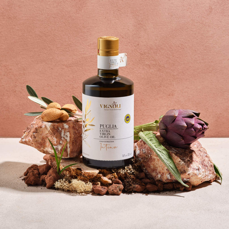 Vignoli Extra Virgin Olive Oil IGP Puglia - Intense front of 16.9oz bottle on rocks with artichoke
