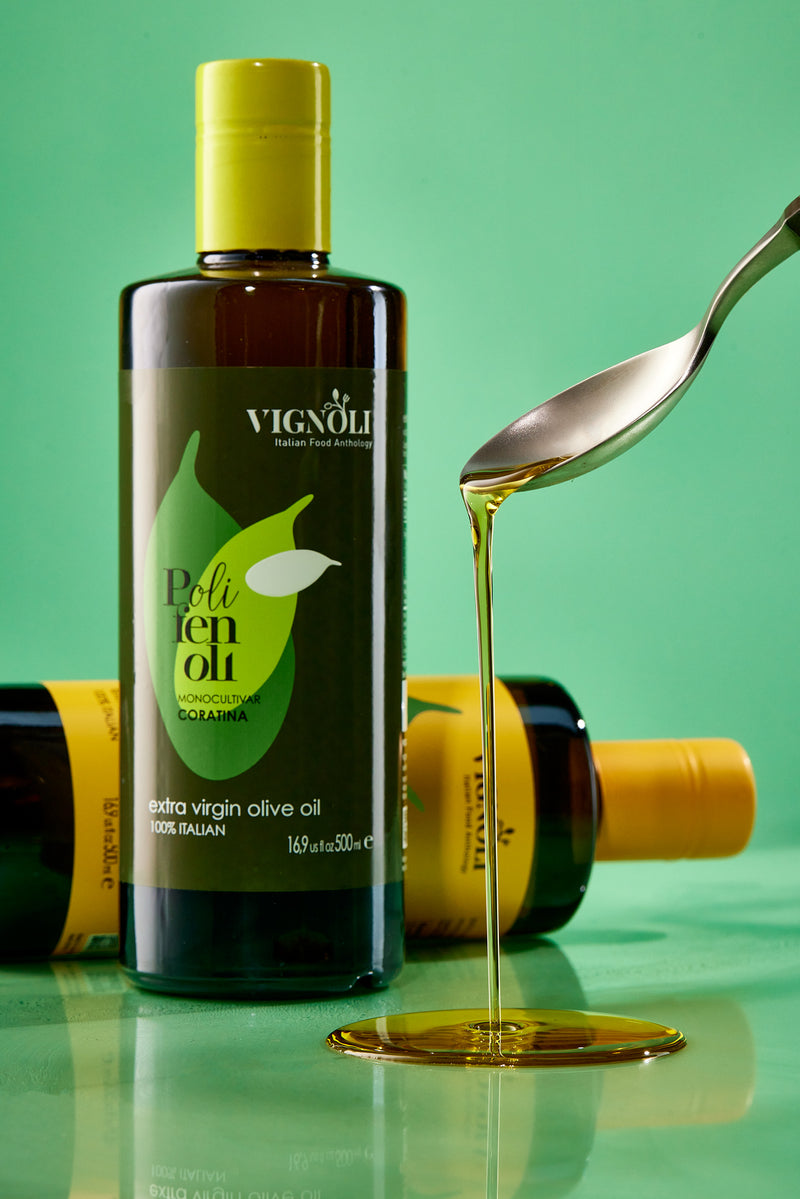Coratina Monocultivar Extra Virgin Olive Oil front of 16.9oz bottle pouring out of spoon