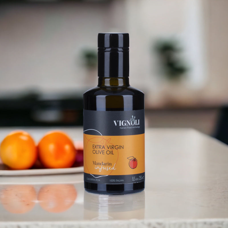 Vignoli Mandarin Infused Extra Virgin Olive Oil front of 8.5oz bottle on table with mandarins in background