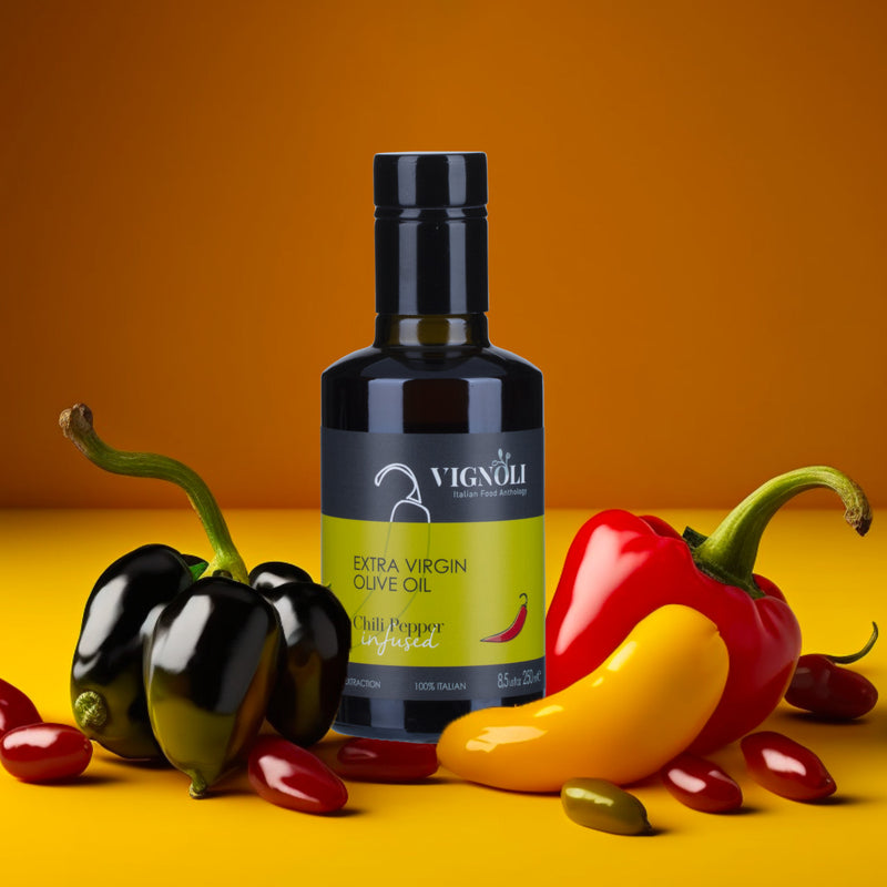 Chili Pepper Infused Extra Virgin Olive Oil front of 8.5oz bottle on table with peppers