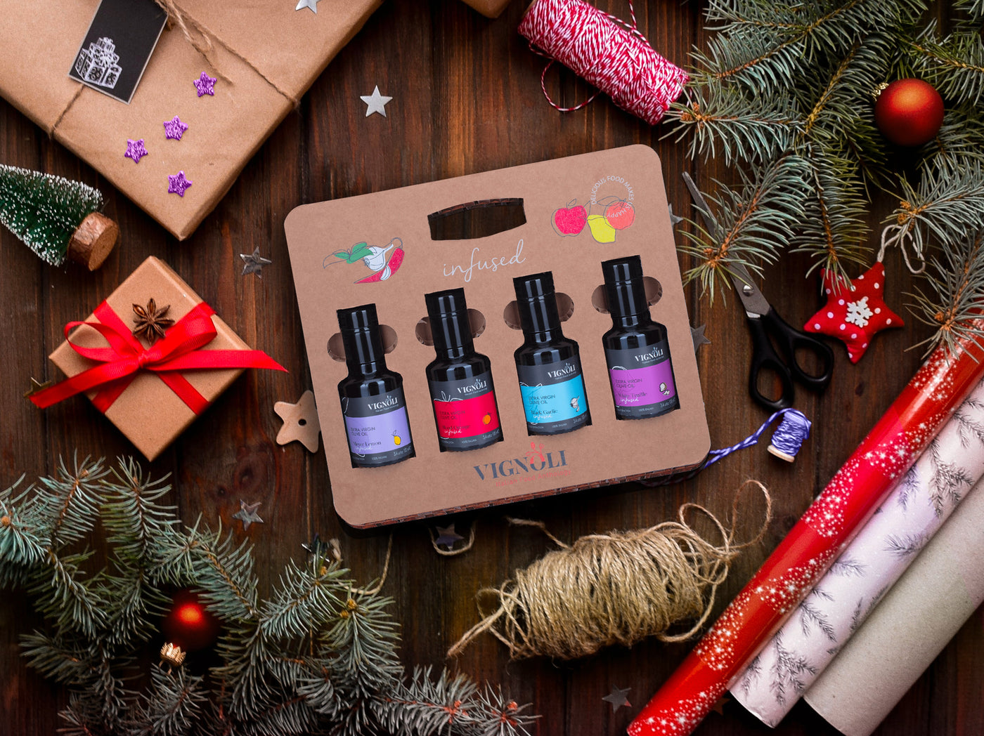 Set of nail polish bottles in a decorative box surrounded by Christmas decorations on a wooden surface.