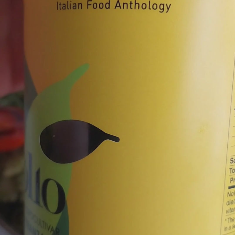 Vignoli Peranzana Monocultivar Extra Virgin Olive Oil front of 16.9oz bottle pouring over pasta 