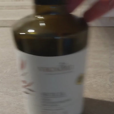 Vignoli Extra Virgin Olive Oil IGP Sicilia - Delicate front of 16.9oz bottle being poured over sliced yams