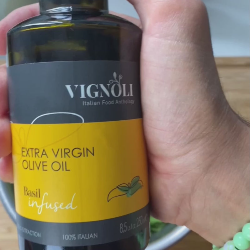 Basil Infused Extra Virgin Olive Oil front of 8.5oz bottle being poured over salad