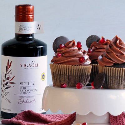 Vignoli Extra Virgin Olive Oil IGP Sicilia - Delicate front of 16.9oz bottle with chocolate cupcakes