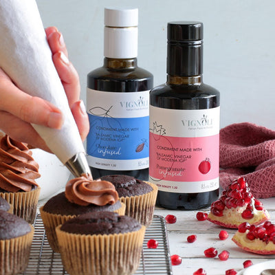 Vignoli Pomegranate Infused Balsamic Vinegar front of 8.5oz bottle with chocolate cupcakes
