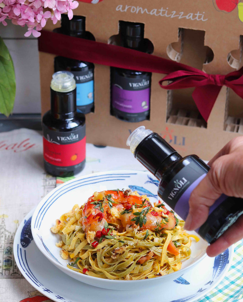 Citrus Meets Savory Infused Extra Virgin Olive Oil Gift Set with oil pouring over prawn pasta