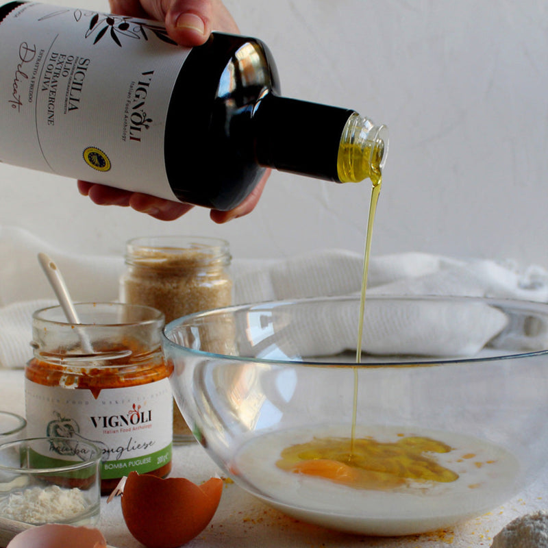 Vignoli Extra Virgin Olive Oil IGP Sicilia - Delicate front of 16.9oz bottle being poured into mixing bowl