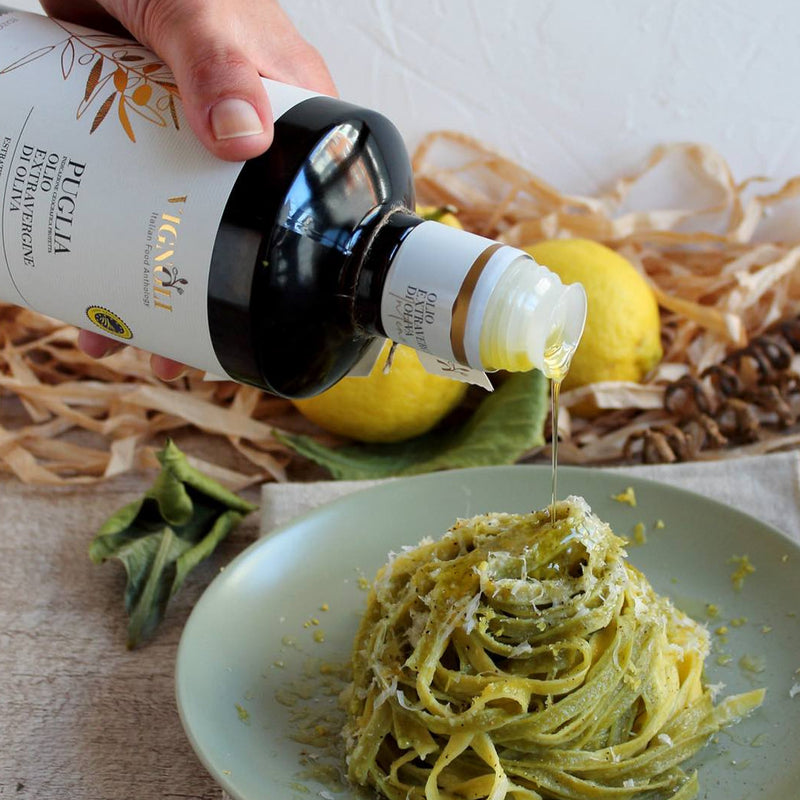 Vignoli Extra Virgin Olive Oil IGP Puglia - Intense front of 16.9oz bottle being poured over pasta on table