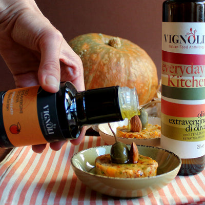 Vignoli Mandarin Infused Extra Virgin Olive Oil front of 8.5oz bottle pouring over pumpkin pate