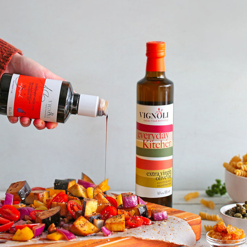 Vignoli Fig Infused Balsamic Vinegar front of 8.5oz bottle pouring over mixed vegetables