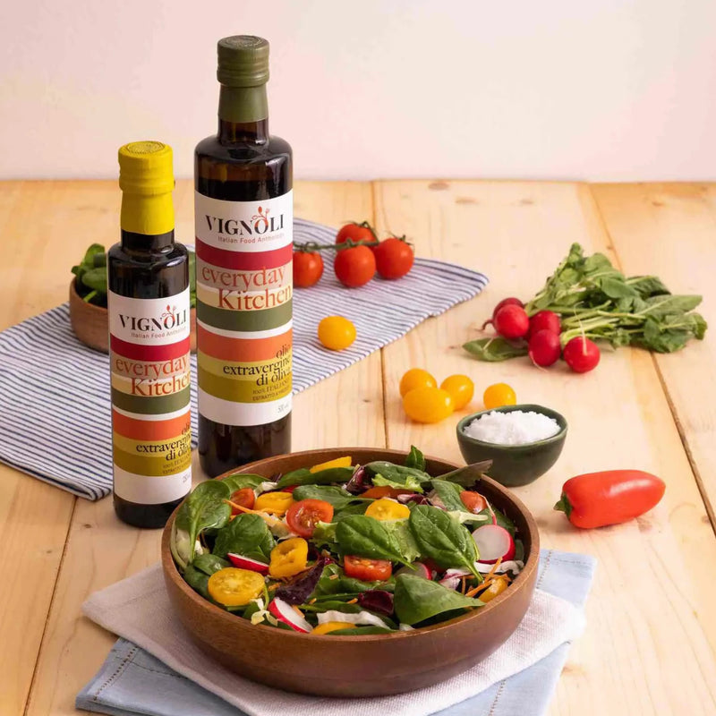 Extra Virgin Olive Oil - Everyday Kitchen front of 16.9oz bottle on table with salad