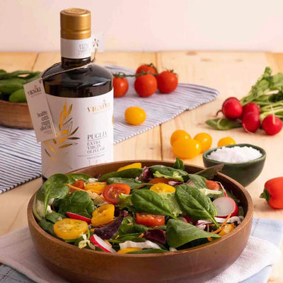Vignoli Extra Virgin Olive Oil IGP Puglia - Intense front of 16.9oz bottle with salad in bowl